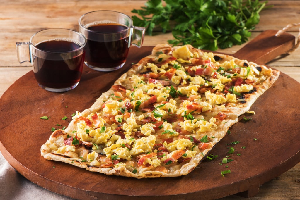 Here’s a fun way to prepare breakfast. Serve up these egg and bacon pizzas with ketchup on the side.