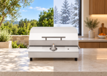 Kenyon electric grill shown in a split seasonal setting, with a sunny green outdoor patio on the left and a warm modern kitchen with snow-covered trees outside on the right.