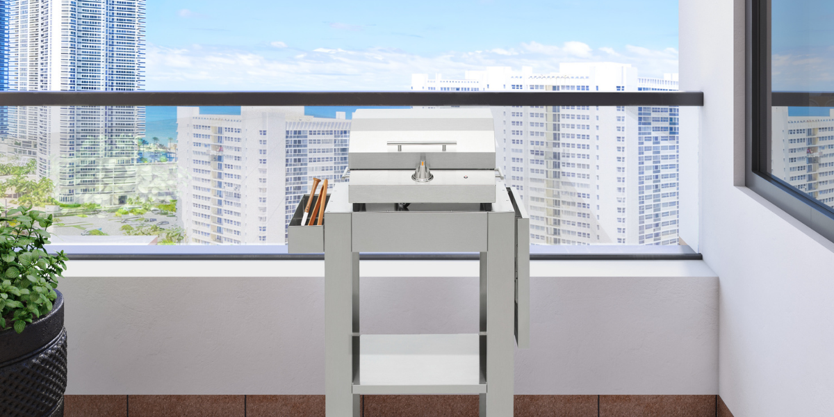 Kenyon g2 Grill + Stand on a balcony with a city skyline in the background