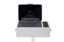 Stainless steel built-in electric grill with an open black lid and touch controls, mounted on a post against a black background.