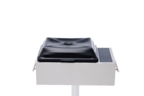 Stainless steel built-in electric grill with a black lid and touch controls, mounted on a post against a black background.
