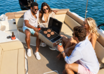 a group of friends grilling on a boat