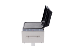 side view of Kenyon stainless steel electric grill with open lid, IntelliKEN touch controls, pedestal mount, and empty grill grate on a black background.