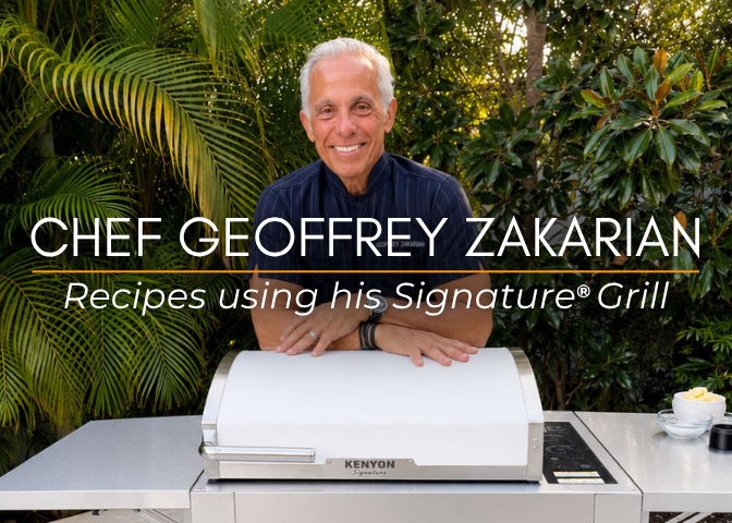 Chef Geoffrey Zakarian stands behind a Kenyon Signature electric grill in a tropical outdoor kitchen, smiling at the camera. The image features the text “Chef Geoffrey Zakarian – Recipes using his Signature® Grill” and serves as a thumbnail for a collection of recipes.