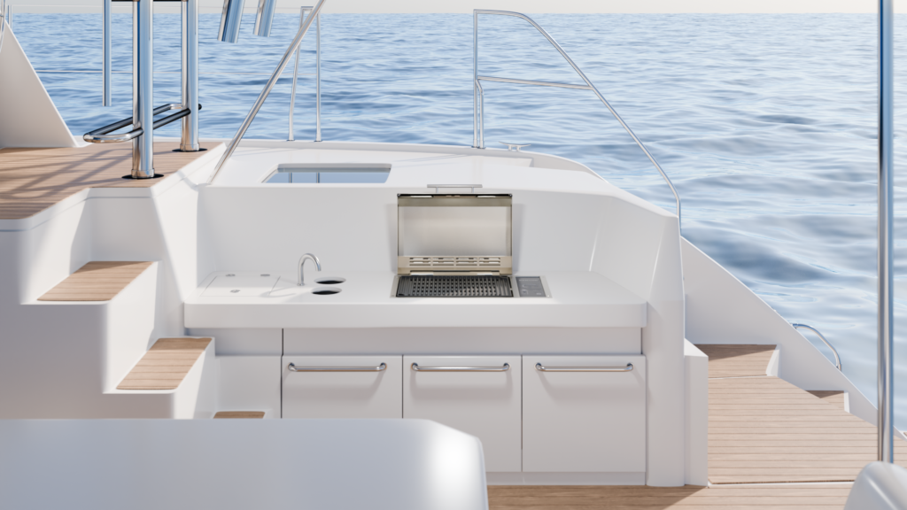 Kenyon electric grill with stainless steel lid built into a modern yacht’s outdoor galley, surrounded by white cabinetry and teak decking with an ocean view.